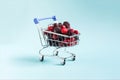 The concept of using quick-frozen products, a mix of frozen berries in a cart