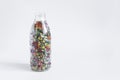 The concept of using quick-frozen products, a transparent bottle with a mixture of frozen vegetables