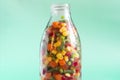 The concept of using quick-frozen vegetables. Frozen vegetables in a transparent bottle on a light background .