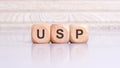 concept of USP word on wooden cubes, wooden background