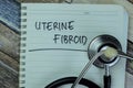 Concept of Uterine Fibroid write on book with stethoscope isolated on Wooden Table