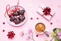 Concept Valentine`s Day. Chocolate candies and coffee, hearts on a pink background. Flat lay copy space. Greeting card