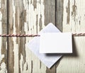 Concept: Valentine`s Day. Envelope for a love letter on a red rope on a wooden white background Royalty Free Stock Photo
