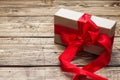 Concept Valentine`s Day. Gift box with red bow on wooden table. copy space Royalty Free Stock Photo