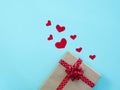 The concept of Valentine\'s day, a gift with hearts on a blue background.