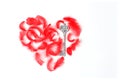 Concept for Valentine`s Day. heart lined with red feathers and a silver key. Flat lay, top view, space for text
