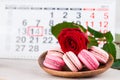 Concept Valentine`s Day, red rose and pastries on background on