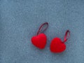 The concept of Valentine`s Day. Two red hearts on a gray background, top view, space to copy.