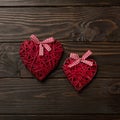 Concept of Valentine`s Day. Wicker hearts on dark wooden backgro