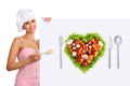 Concept vegetarian diet chef woman pointing billboard salad heart shape Royalty Free Stock Photo