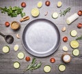 The concept of a vegetarian meal, parsley, sliced zucchini and cucumbers, cherry tomatoes, wooden spoon, lemon, lime, spices, laid