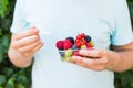 Concept of vegetarians, raw food and diets - close-up of man hold fruits and berries Royalty Free Stock Photo