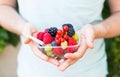 Concept of vegetarians, raw food and diets - close-up of man`s hands hold fruits and berries Royalty Free Stock Photo