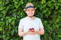 Concept of vegetarians, raw food and diets - Handsome man hold fruits and berries Royalty Free Stock Photo
