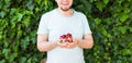 Concept of vegetarians, raw food and diets - Handsome man hold fruits and berries Royalty Free Stock Photo