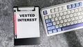 Concept of Vested Interest write on paperwork isolated on Wooden Table Royalty Free Stock Photo
