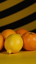 Vibrant scene featuring blackandyellow backdrop with lemons and oranges on display Cheerful Bright Royalty Free Stock Photo
