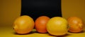 Vibrant scene featuring blackandyellow backdrop with lemons and oranges on display Cheerful Bright Royalty Free Stock Photo