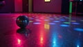 A vibrantly reflected disc ball illuminates an empty colorful 80sstyle disco dancefloor Royalty Free Stock Photo