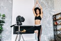 An African-American woman records yoga classes Royalty Free Stock Photo