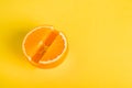 Concept Vitamin S. Fresh orange in pill form Yellow background. Metaphor Minimalism Close-up