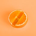 Concept Vitamin C. Fresh orange in pill form Orange background. Metaphor Minimalism Close-up