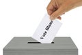 Hand putting a ballot with white vote written in French