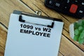 Concept of 1099 vs w2 Employee write on paperwork isolated on Wooden Table