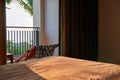 Concept warm tropical evening in hotel room on the beach. Sunny evening light illuminates the bed through the open door. Royalty Free Stock Photo