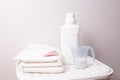 the concept of washing white linen, bleach and detergent on a white laundry basket