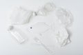 Concept of water and fish pollution, plastic debris in ocean, plastic bottle, fish, bag, spoon fork on white background, Royalty Free Stock Photo