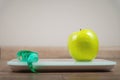 concept of weight loss, diet, healthy food, floor scales, measuring tape and an apple. Side view Royalty Free Stock Photo