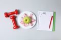 Concept of weight loss and healthy nutrition with apple and measuring tape Royalty Free Stock Photo