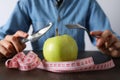 Concept of weight loss and healthy nutrition with apple and measuring tape Royalty Free Stock Photo