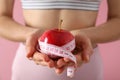 Concept of weight loss and healthy nutrition with apple and measuring tape Royalty Free Stock Photo