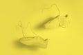 The concept of weightlessness and lightness. a pair of yellow sneakers flying in the air on a yellow background