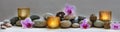 Concept of wellbeing with pebbles, orchids and candles, panoramic