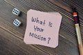 Concept of What is your mission? write on sticky notes isolated on Wooden Table Royalty Free Stock Photo