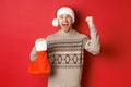 Concept of winter holidays, new year and celebration. Amazed and happy man shouting for joy, found gift inside christmas Royalty Free Stock Photo