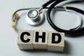 Concept of The wooden Cubes with the word CHD with stethoscope on white background Royalty Free Stock Photo