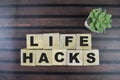 Concept of The wooden Cubes with the word Life Hacks on wooden background Royalty Free Stock Photo