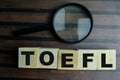 Concept of The wooden Cubes with the word TOEFL on wooden background
