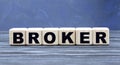 Concept word broker on cubes on a blue background