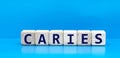 concept word CARIES on cubes on a blue background Royalty Free Stock Photo