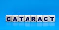 concept word CATARACT on cubes on a blue background Royalty Free Stock Photo