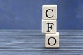 Concept word CFO on cubes on a beautiful gray blue background