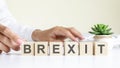 concept word forming with cube on wooden desk background - Brexit Royalty Free Stock Photo