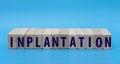 Concept word INPLANTATION on cubes on a blue background Royalty Free Stock Photo