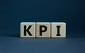 Concept word `KPI - key perfomance indicator` on cubes on a beautiful grey background. Business concept. Copy space