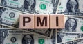 Concept word `PMI` on cubes on a beautiful background from dollar bills. Business concept Royalty Free Stock Photo